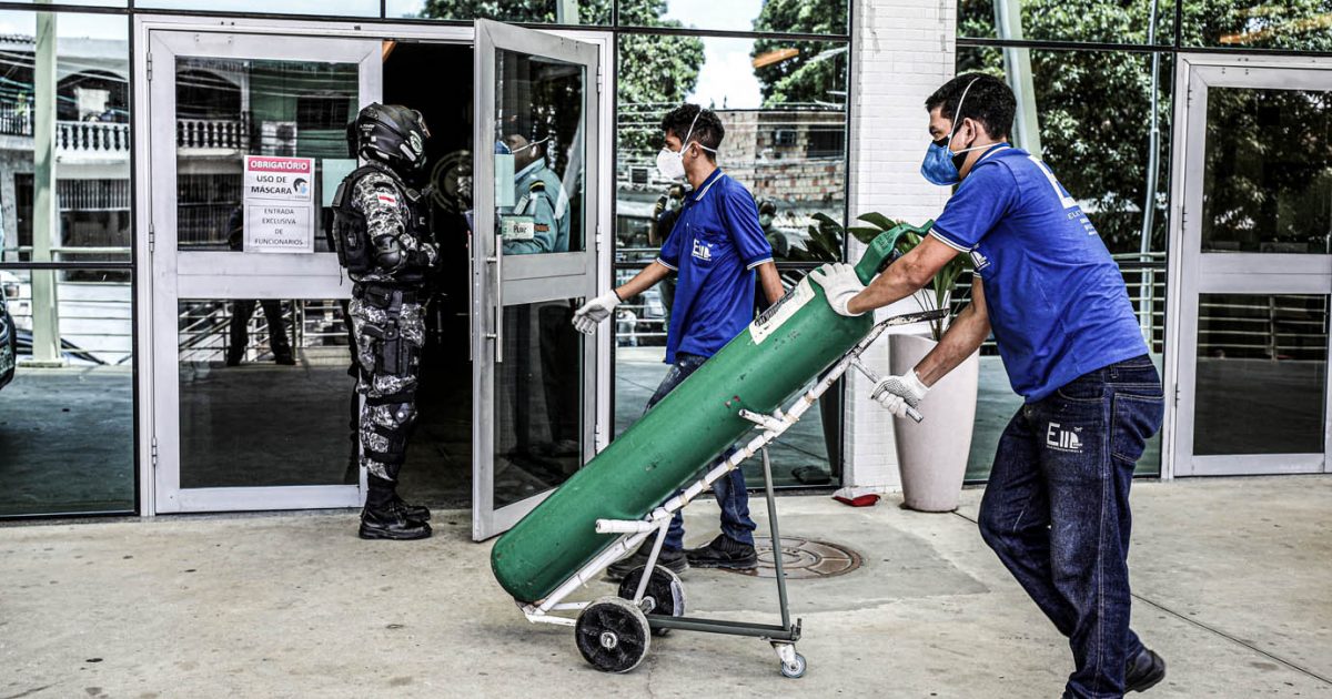 A worker arrives with an oxygen cylinder at Getulio Vargas hospital, amid the coronavirus disease (COVID-19) outbreak in Manaus, Brazil January 14, 2021.